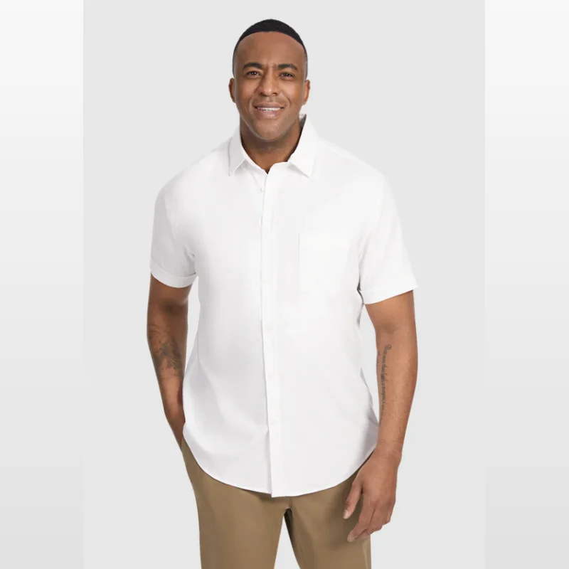 Man wearing a white Johnny Bigg Deniro stretch short sleeve shirt with a pocket and button-down collar, paired with tan chinos.
