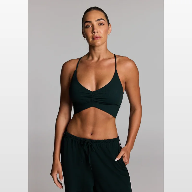 Woman wearing a dark green Luxesoft Rouched Low Support Sports Bra by Rockwear.
