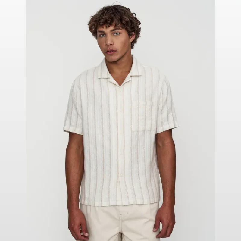 Man wearing a short sleeve, oat-coloured shirt with vertical stripes and a Cuban collar.