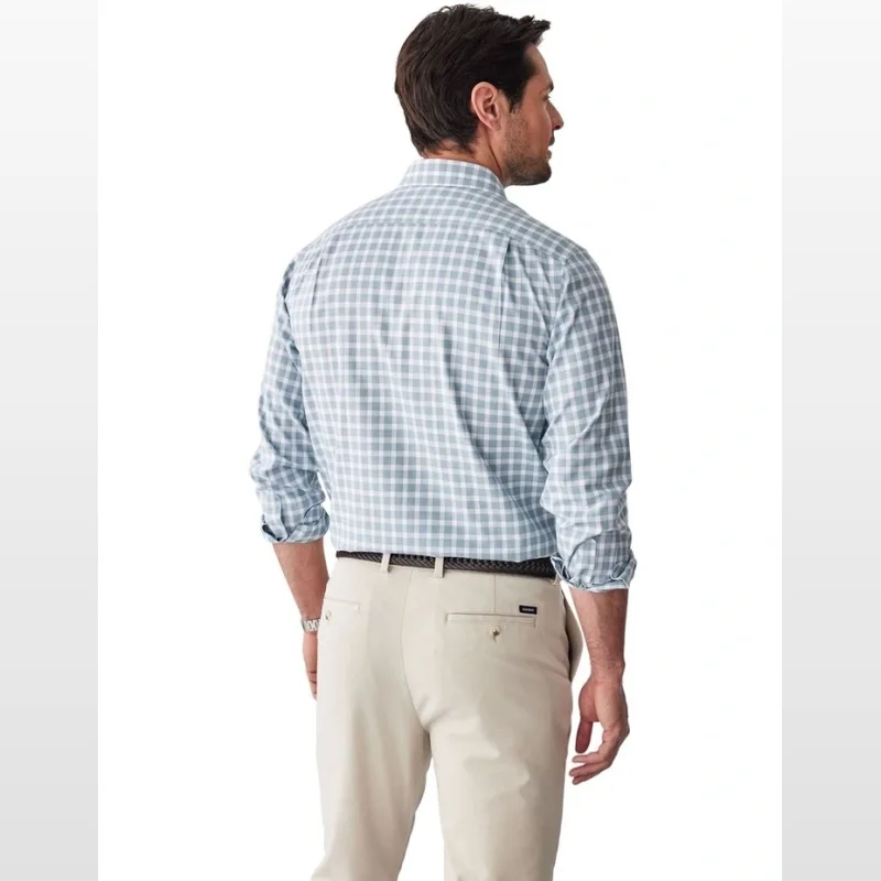 Man wearing a sage green and white checked long sleeve non-iron twill shirt from behind.