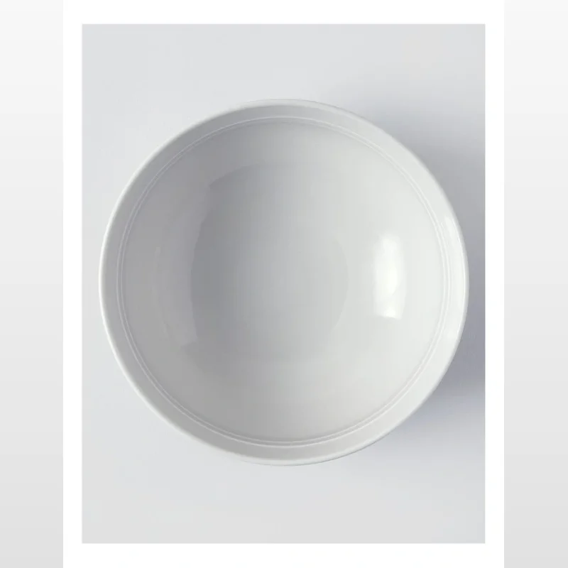 A top-down view of a plain grey porcelain cereal bowl with subtle concentric rings on the rim.