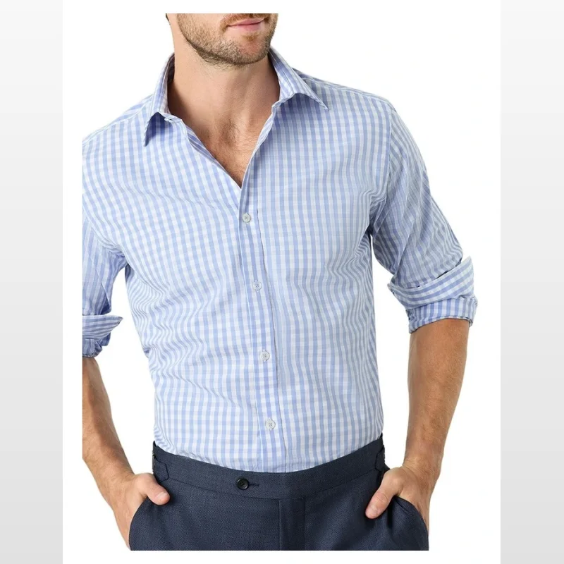 Man wearing a light blue and white gingham long-sleeved shirt with a cutaway collar and french cuffs.