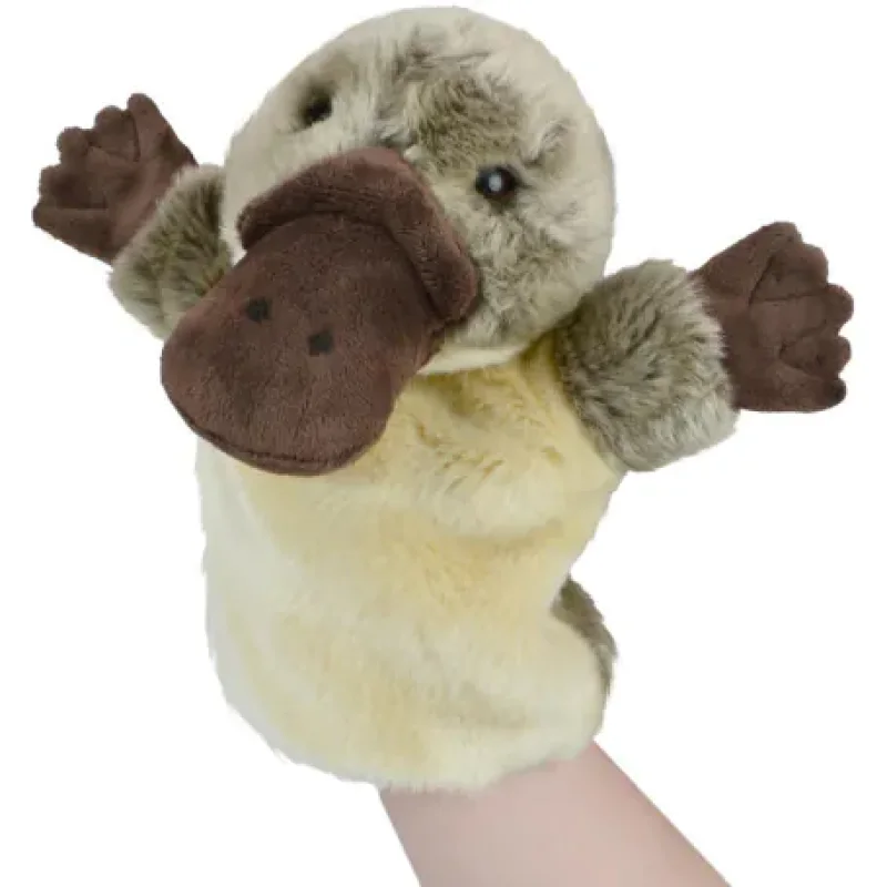 A plush hand puppet of a platypus, with a brown bill and paws, and a cream-coloured body, being worn on a person's hand.