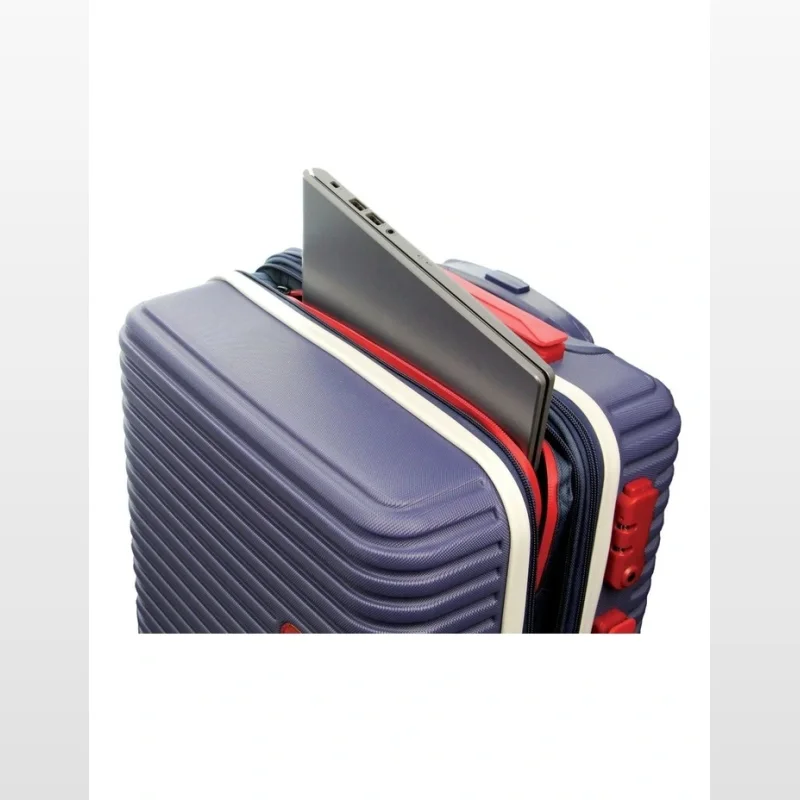 Close-up of a navy blue hard-shell cabin suitcase with a laptop inserted into a front pocket.