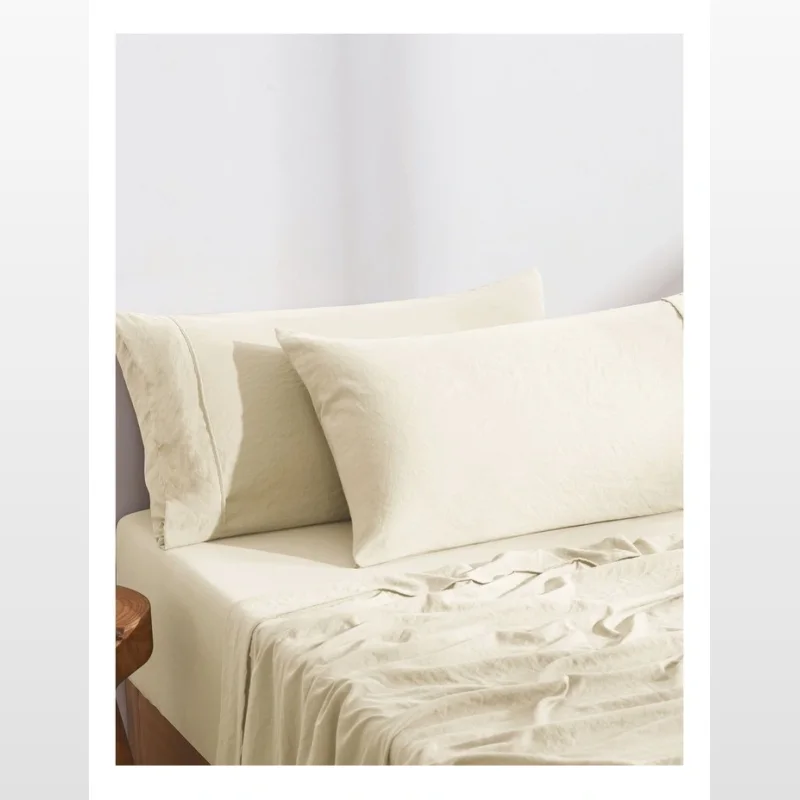 Two natural coloured superfine washed microfibre king pillowcases on a bed.