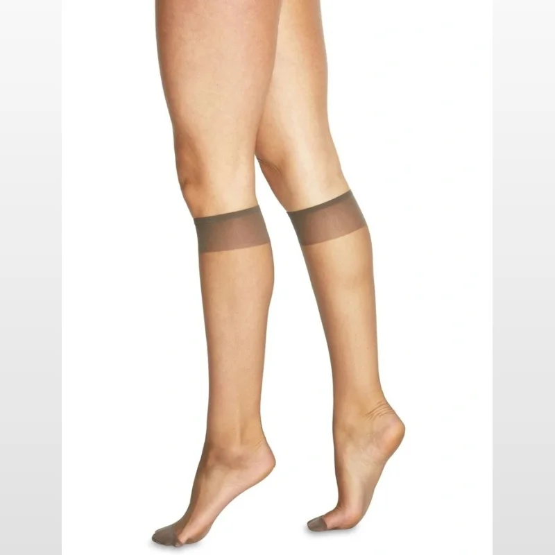 Close-up of a woman's legs wearing ultra sheer, fumo-coloured knee-high hosiery with a comfort band just below the knee and reinforced toes.