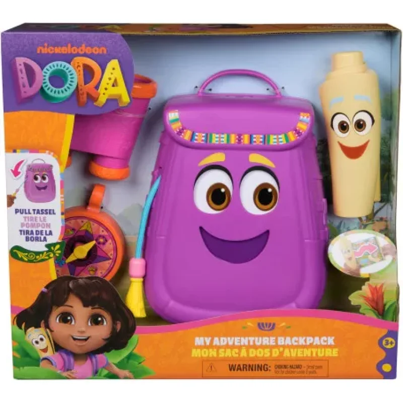 A purple Dora The Explorer backpack with a smiling face, featuring a compass, binoculars, and a map accessory, in its original packaging.