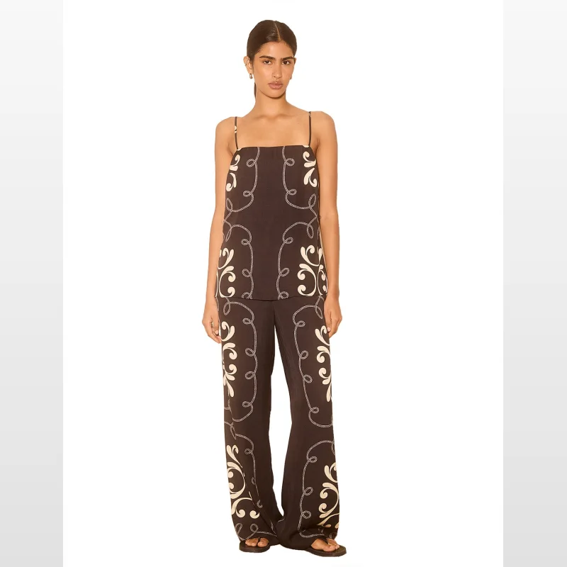 Model wearing the MON RENN Savanna Top, a brown sleeveless top with a cream-coloured rope and scroll print, featuring thin adjustable straps and a straight neckline.