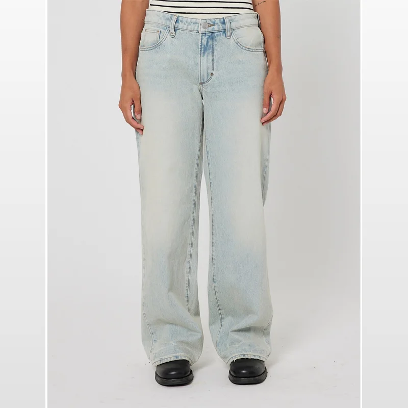 A person wearing light blue, wide-leg, mid-rise jeans with a relaxed fit and subtle fading.