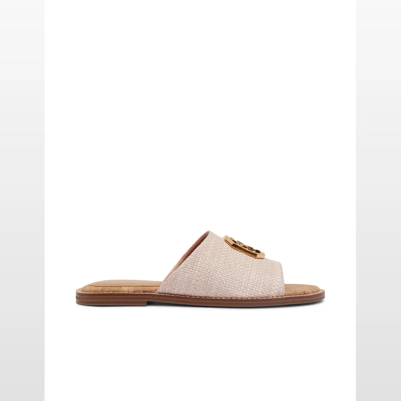 A single GUESS Women's Graysie sandal in soft pink with a textured raffia strap and gold-tone logo emblem, shown from the side on a white background.