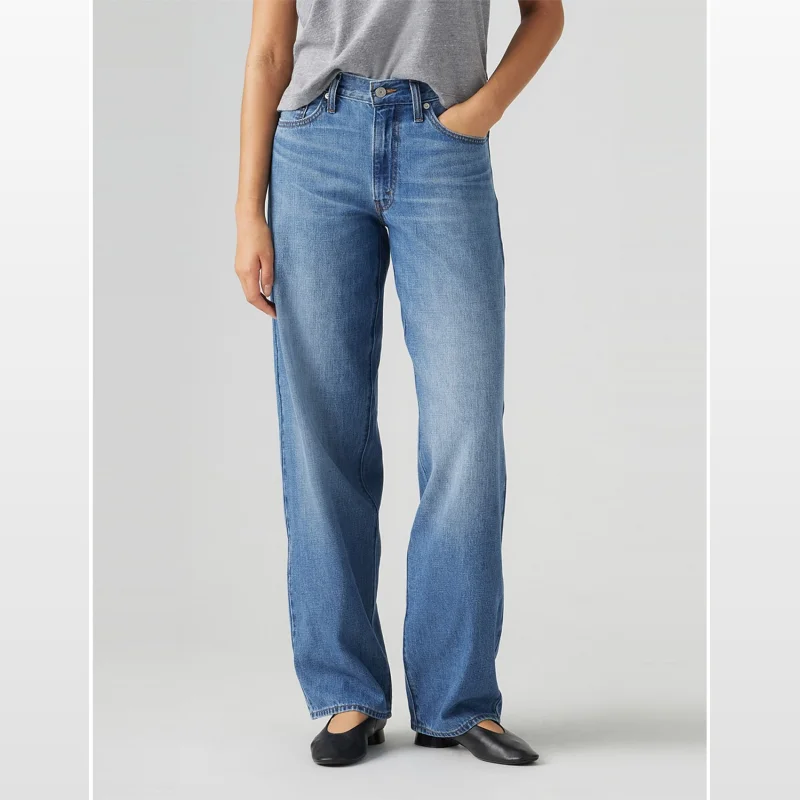 Model wearing Levi's Baggy Dad Mid Rise Straight Leg Jeans in a medium blue wash.