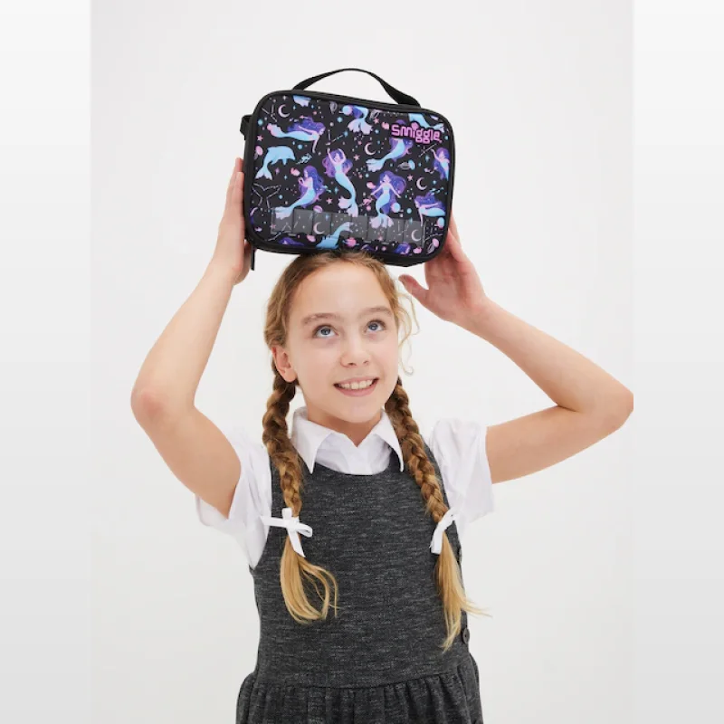 A young girl with braided hair holding a Smiggle lunchbox with a mermaid and celestial print on her head.