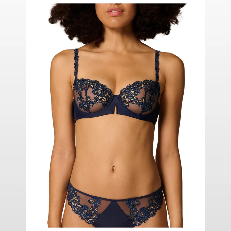Simone Perele Saga Half Cup Bra in navy blue, featuring intricate lace detailing and sheer mesh panels.