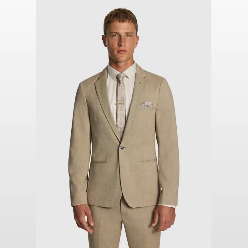 Man wearing a sand-coloured Yd Hayman stretch skinny suit jacket with a textured finish, paired with a light-coloured shirt, patterned tie, and pocket square.