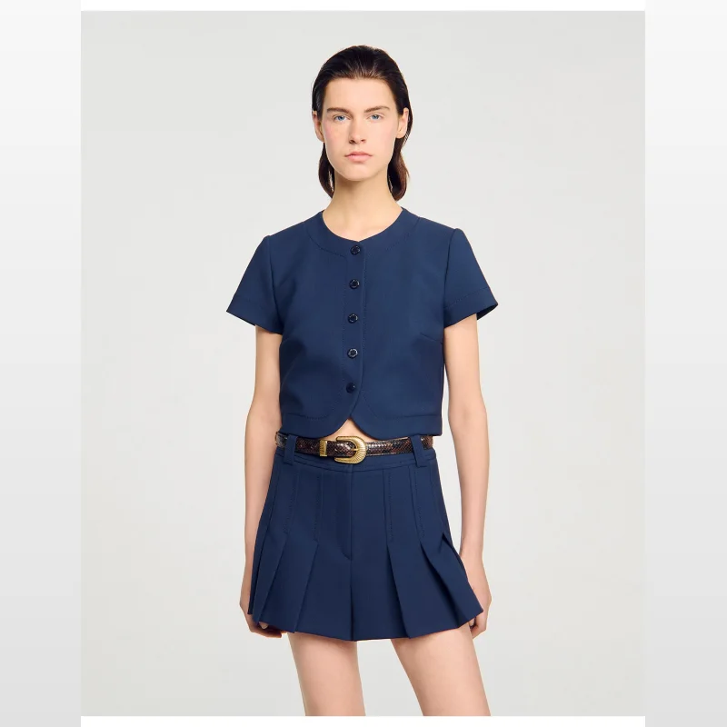 Navy blue Sandro Paris Elianna fine knit crop top with short sleeves, a round neckline, and button fastening down the front. The top has a rounded hem.