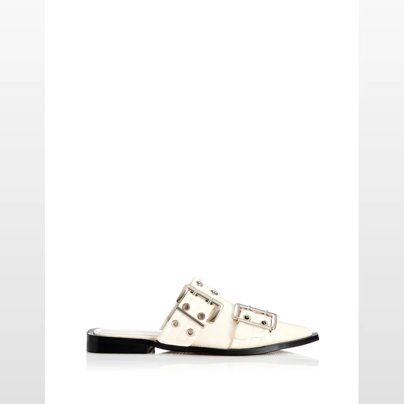 White leather pointed toe mule shoes with double buckle detail and flat heel.