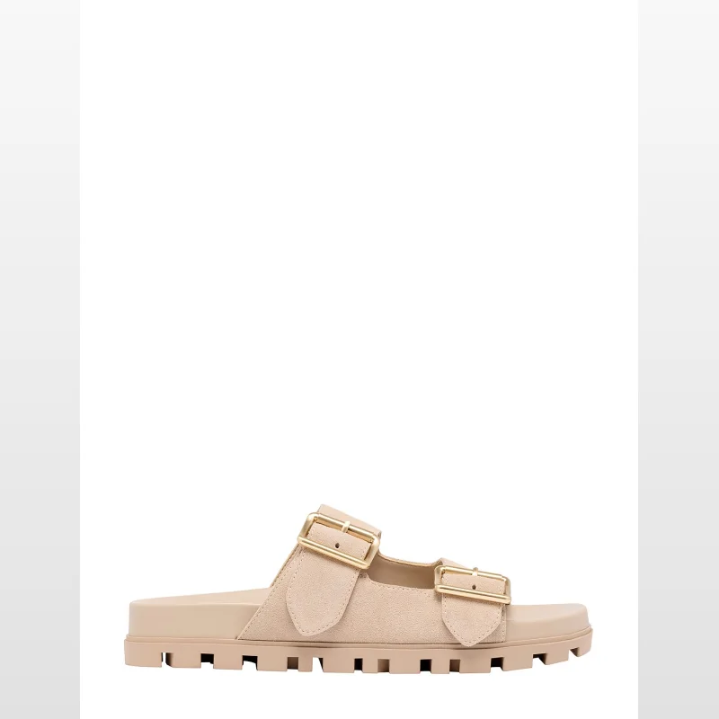 A pair of NINE WEST TIMMA FLAT SANDALS in beige, featuring two adjustable buckle straps and a chunky tread sole.