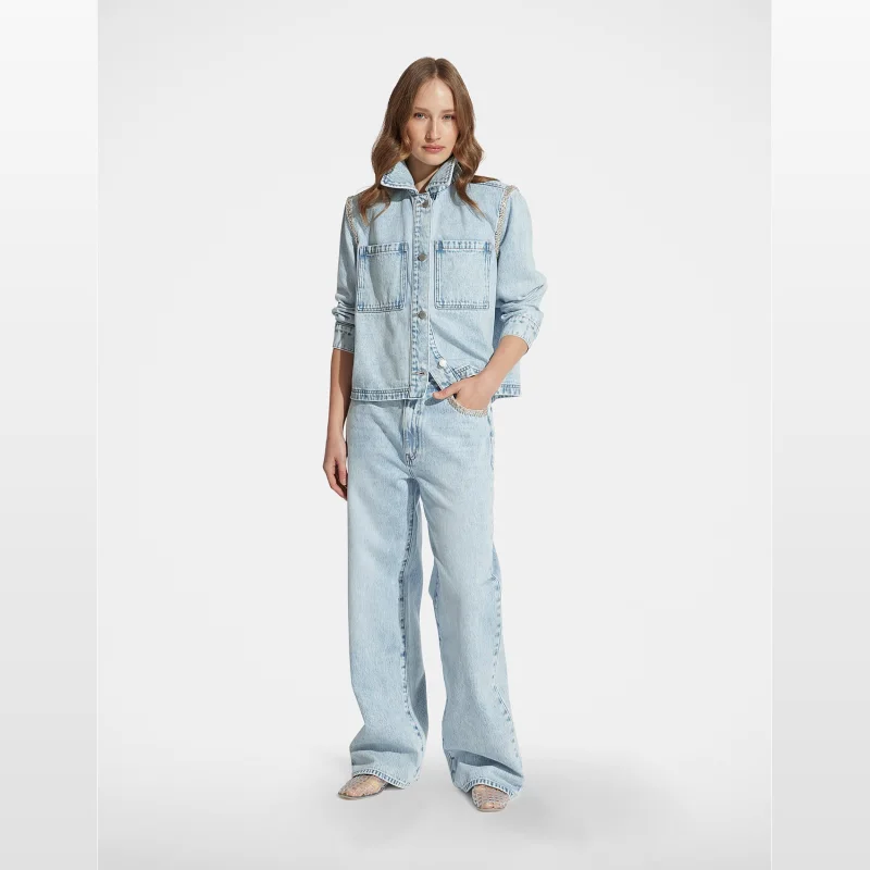 Woman wearing light blue DECJUBA CHRISTINA STRAIGHT LEG JEAN with embellished detail on the shoulders and pockets.