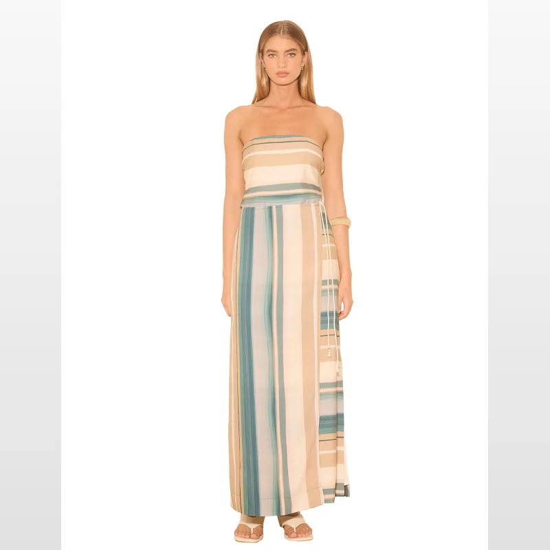 Woman wearing a strapless, full-length maxi dress with a vertical stripe pattern in beige, teal, and cream, featuring a wrap skirt overlay and a beaded drawstring waist.