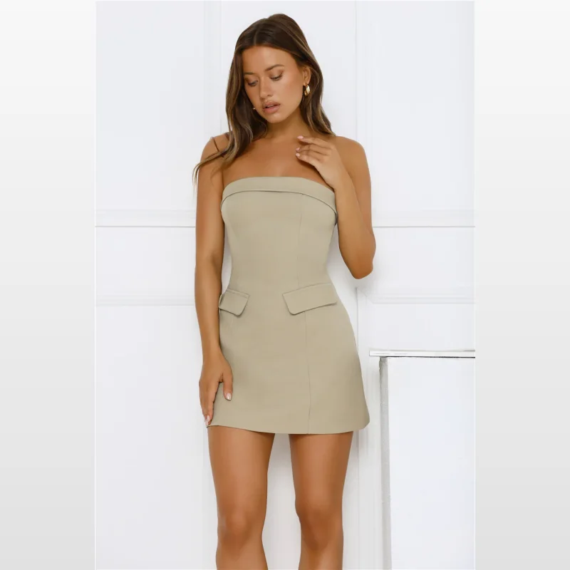 Woman wearing a sage green strapless mini dress with a folded neckline and faux front pockets.