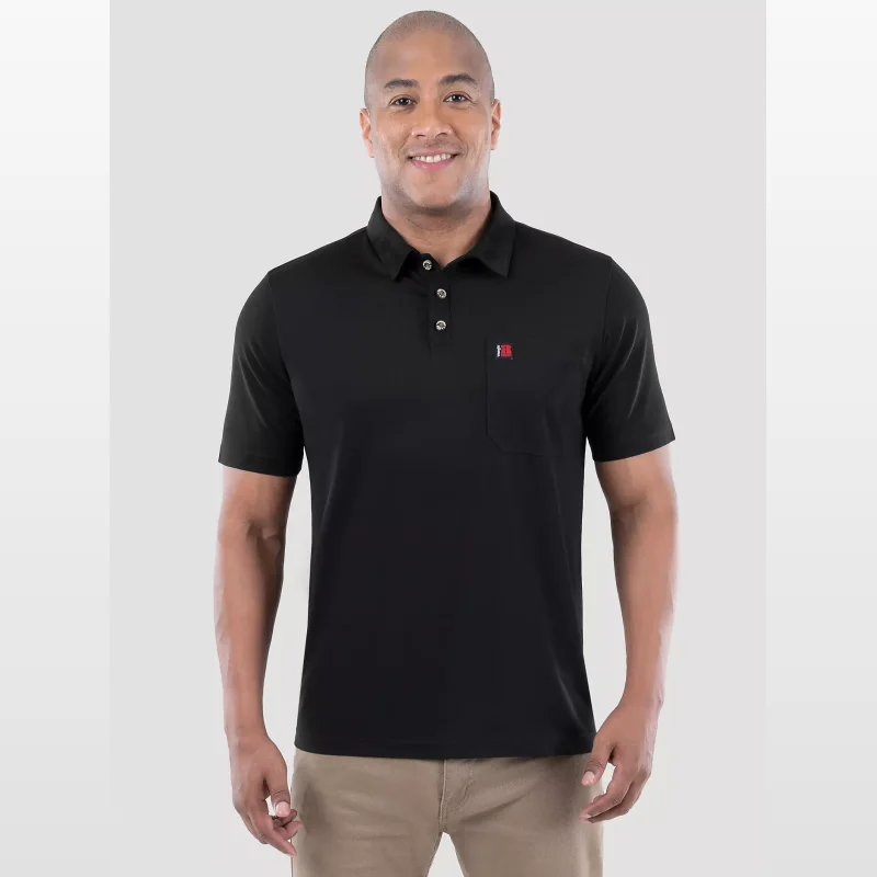 Man wearing a black short-sleeved Wrangler RIGGS WORKWEAR® performance pocket polo shirt with a small red and white logo on the chest pocket.