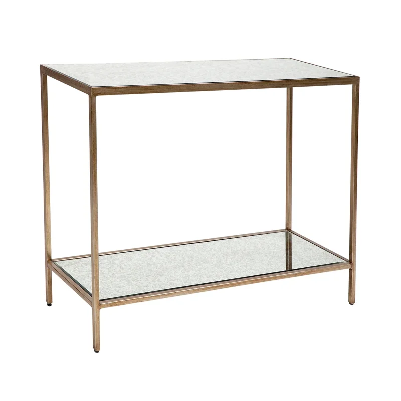 A narrow console table with a gold metal frame and two mirrored glass shelves, presented against a white background.