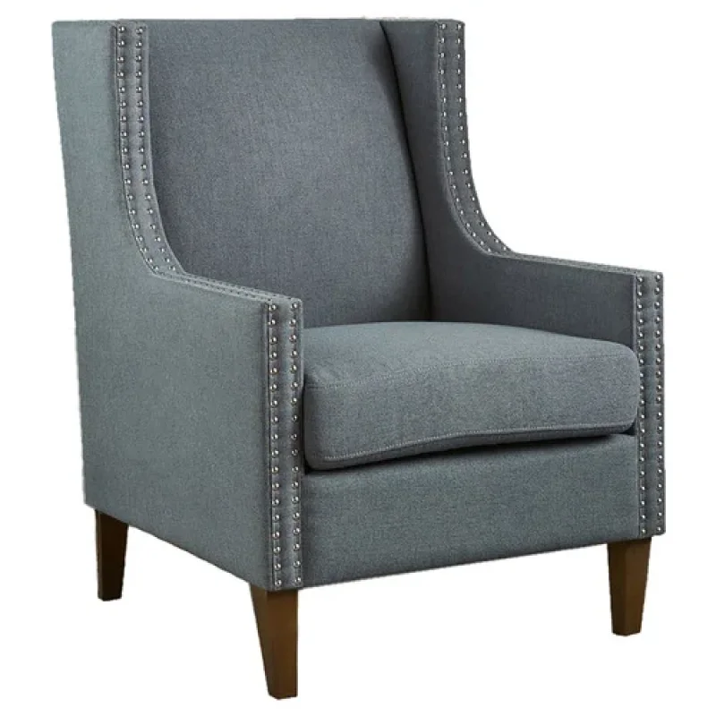 A grey fabric wingback armchair with silver stud detailing and wooden legs.