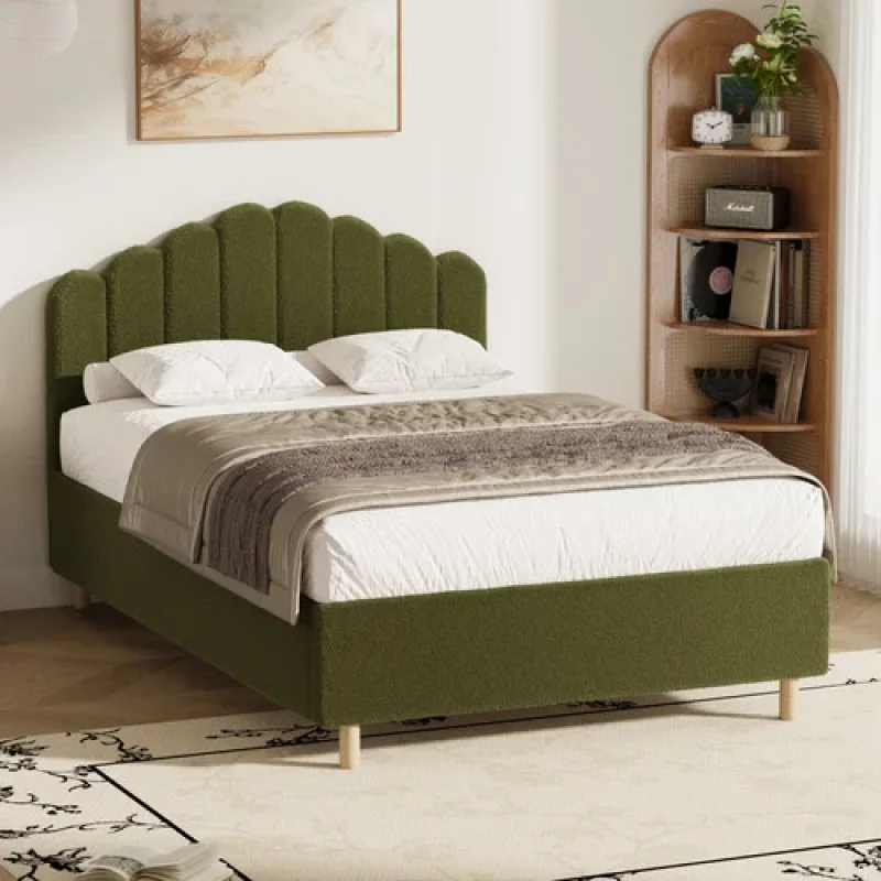 Green Ellora Boucle Queen Bed Frame with a scalloped headboard, upholstered in textured green boucle fabric, shown with white bedding and light wooden legs.