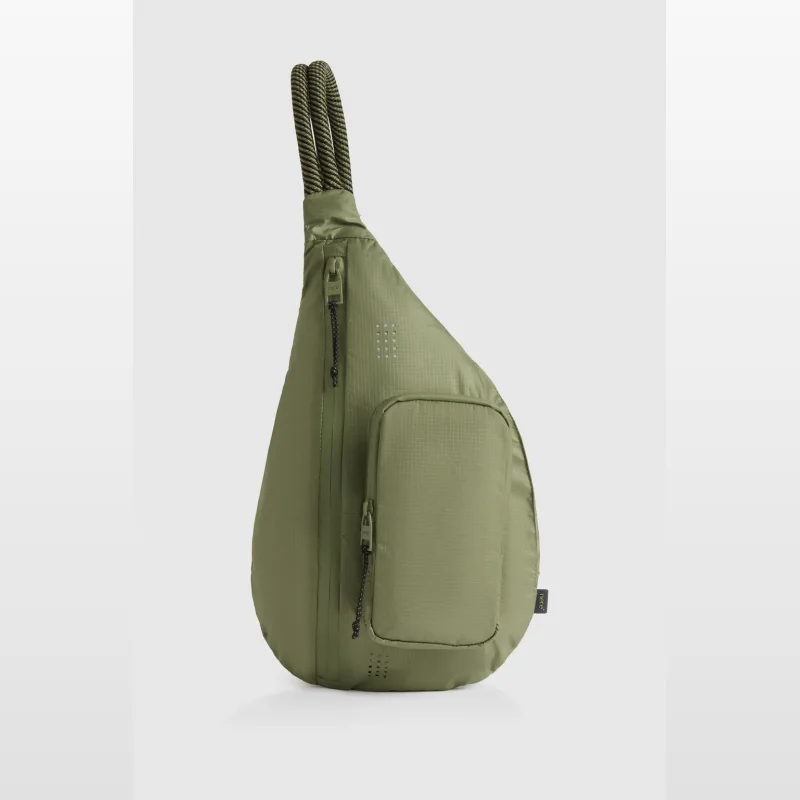 Olive green Nere Momentum Sling Backpack with a rope strap and multiple zippered pockets.