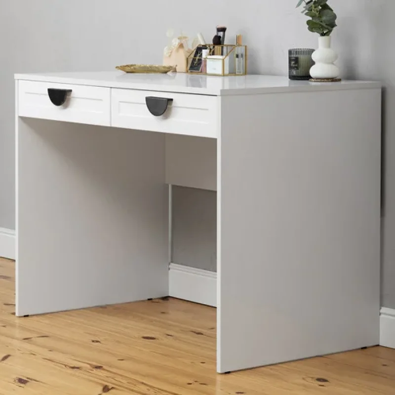 A white Rochester Hamptons desk with two drawers and black handles, styled with decorative items on top.
