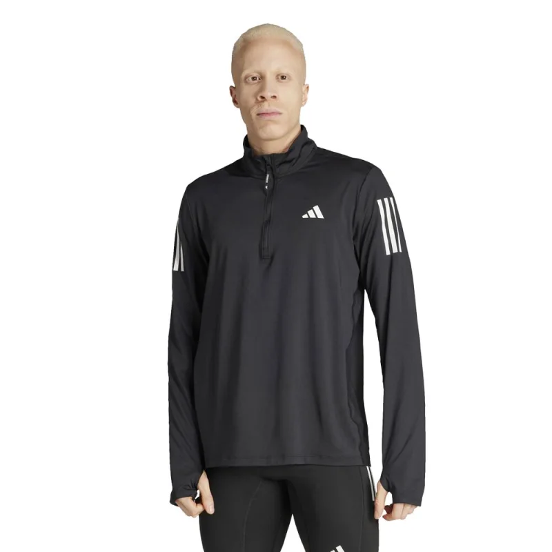 Man wearing a black adidas Own The Run Half Zip running top with white adidas logo and three stripes on the sleeve.