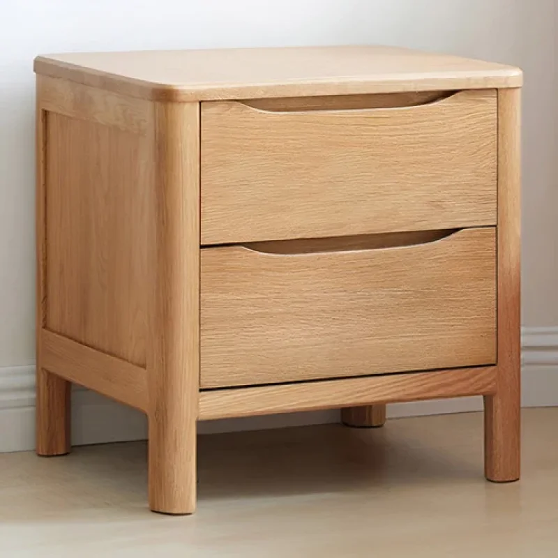 A light oak wood bedside table with two drawers, featuring curved edges and integrated handles.
