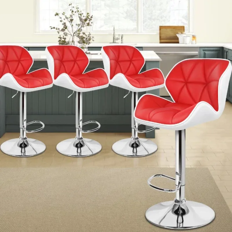 Four red and white adjustable barstools with chrome bases arranged in a kitchen setting.