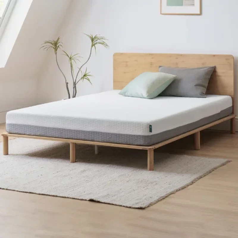 A white and grey double-sided flippable memory foam mattress on a wooden bed frame with a wooden headboard.