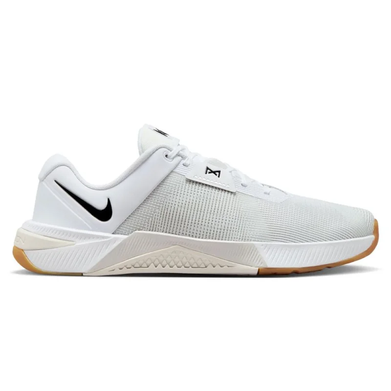 Side view of a white Nike Metcon 10 men's training shoe with a black Nike swoosh on the heel and a gum-coloured sole.