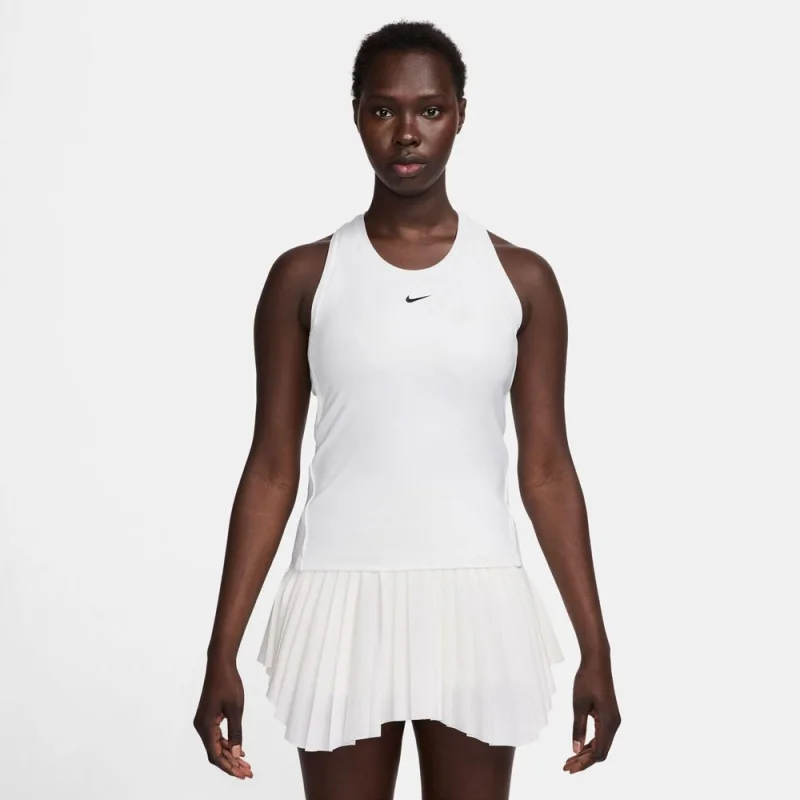 Woman wearing a white Nike Dri-FIT tennis tank top with a high neckline and a black Nike swoosh logo.