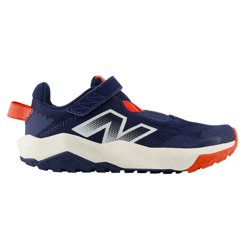 Side view of a New Balance Nitrel V6 PS kids' trail running shoe in navy blue with orange accents and a white midsole.