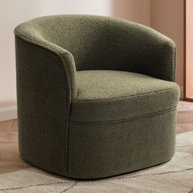 A textured green teddy fabric swivel armchair with a curved back and seat, shown in a living room setting.