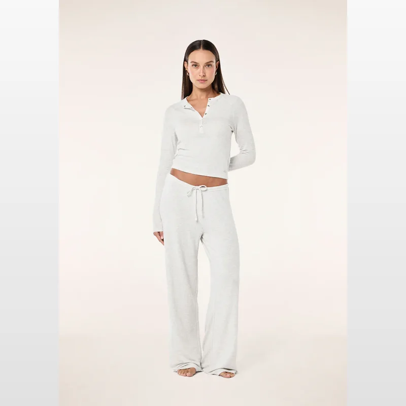 Woman wearing Pe-nation Haven Pant in Snow Marle, a light grey, relaxed-fit knit pant with a drawstring waist.