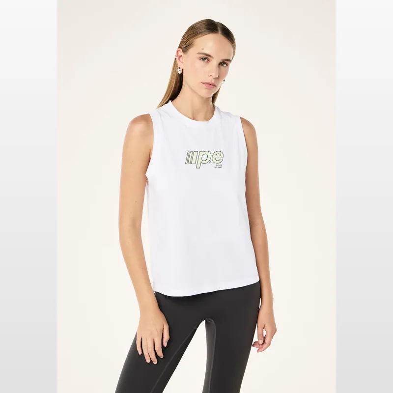 Woman wearing a white P.E Nation Glide Tank with a relaxed fit and a green and black graphic print on the front.