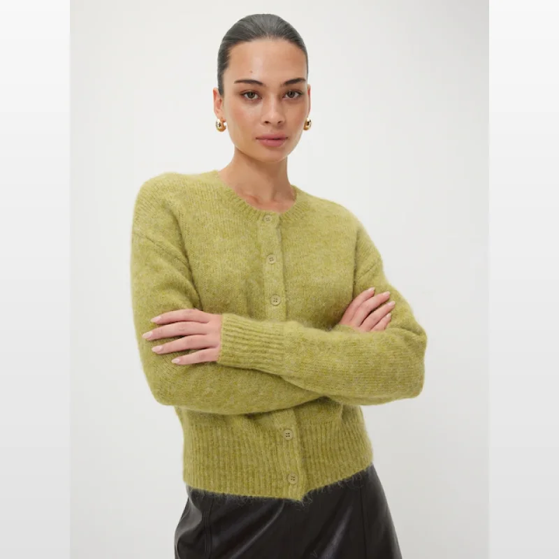Woman wearing a lime green fluffy crew neck cardigan with front button placket and ribbed cuffs and hem.