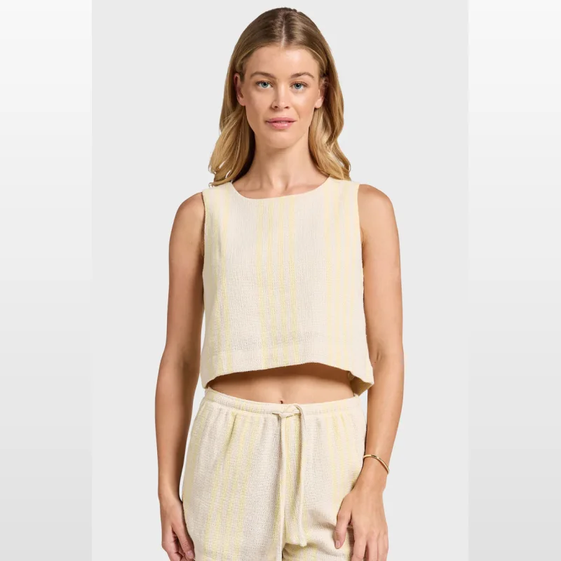 Woman wearing a cream and yellow striped textured cami top with a scoop neckline and button back closure.