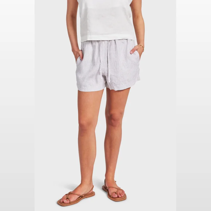 Woman wearing Academy Brand Rory Linen Shorts in a grey and white stripe pattern, featuring an elastic waistband and drawcord.