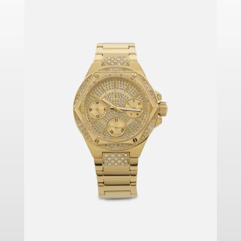 A close-up studio shot of a gold-toned Guess Envy bracelet watch for women, featuring a round face with crystal embellishments and a link bracelet.