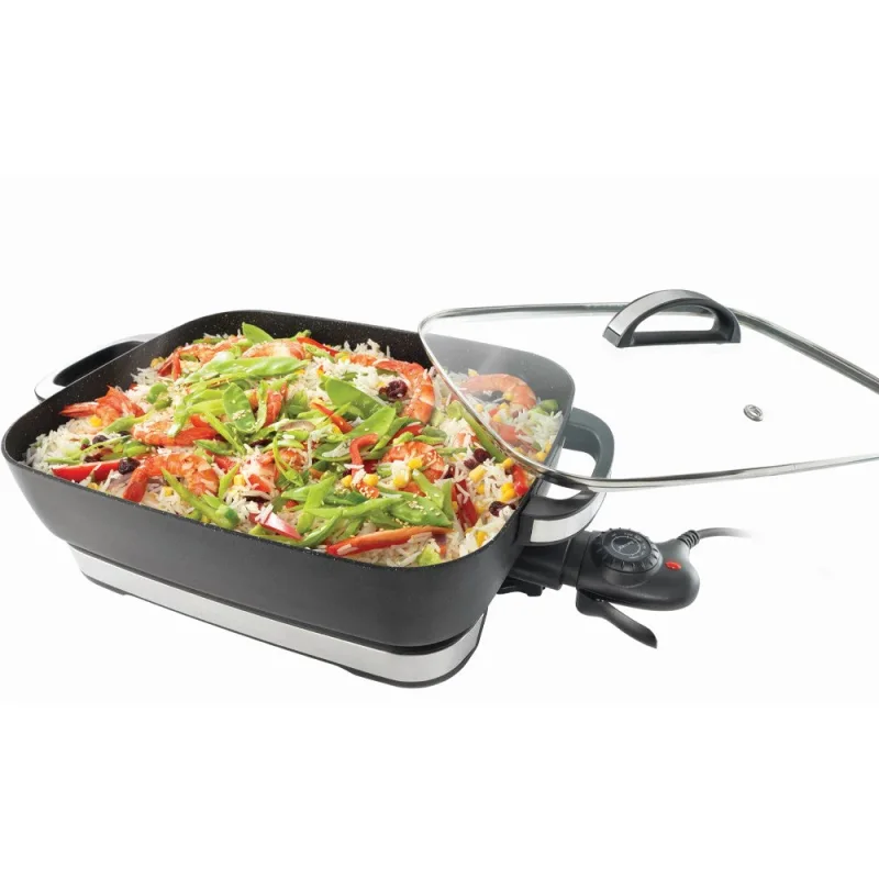 A large, rectangular Baccarat STONE electric banquet frypan filled with a colourful rice dish containing prawns, snow peas, corn, and red capsicum, with a tempered glass lid slightly ajar.