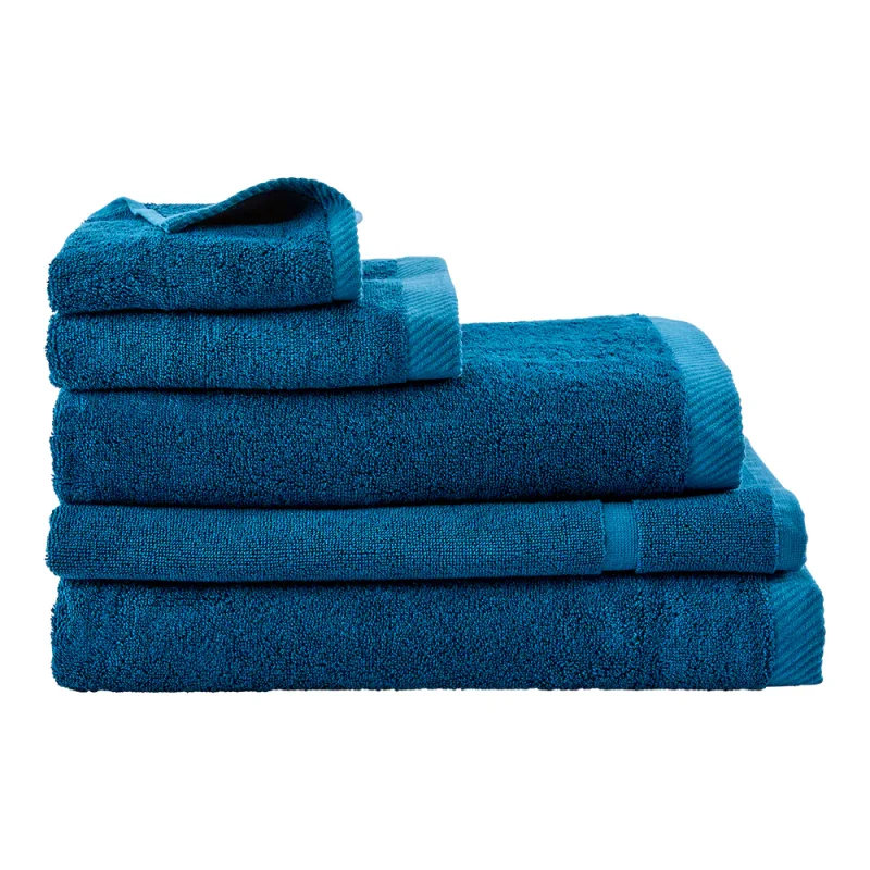 A stack of five teal blue MyHouse Riley Bamboo Cotton towels of varying sizes, including a bath towel, bath sheet, hand towel, face washer, and bath mat.
