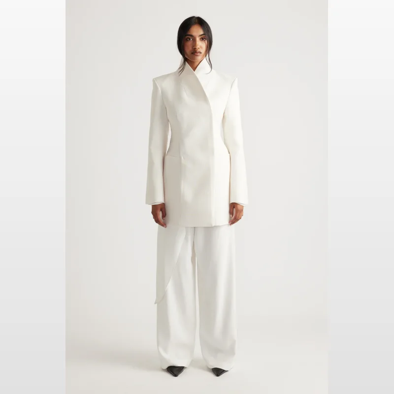 Model wearing white Decjuba Elena Palazzo Pants with a matching blazer.