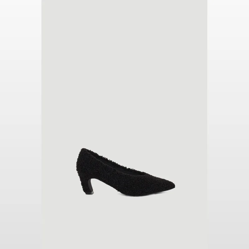 A black, fluffy, pointed-toe pump with a Cuban heel.