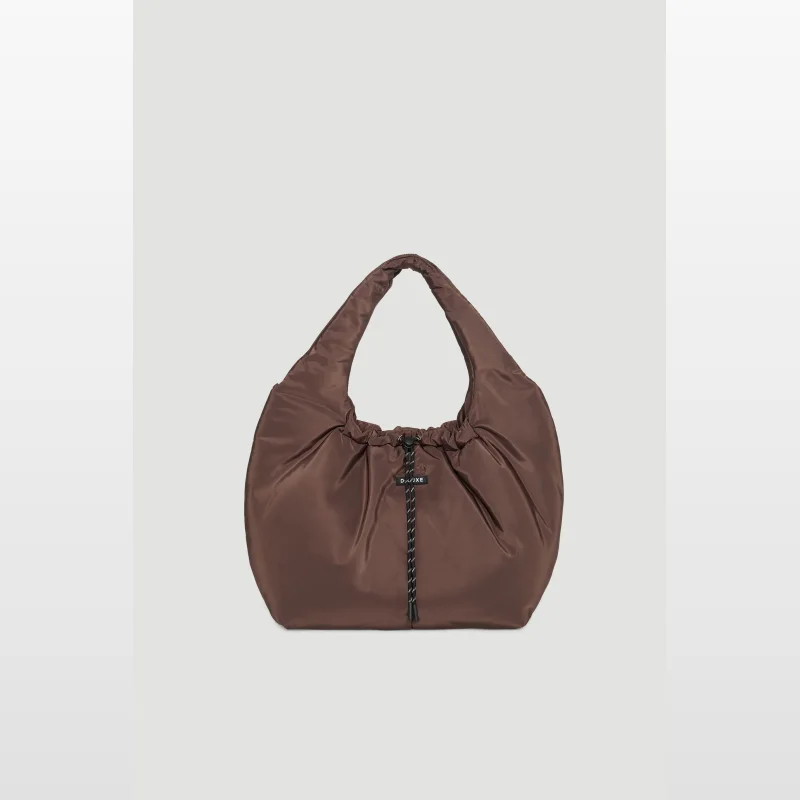 A brown D-Luxe Reese Puffer Bag with a drawstring closure and a black and white rope detail.