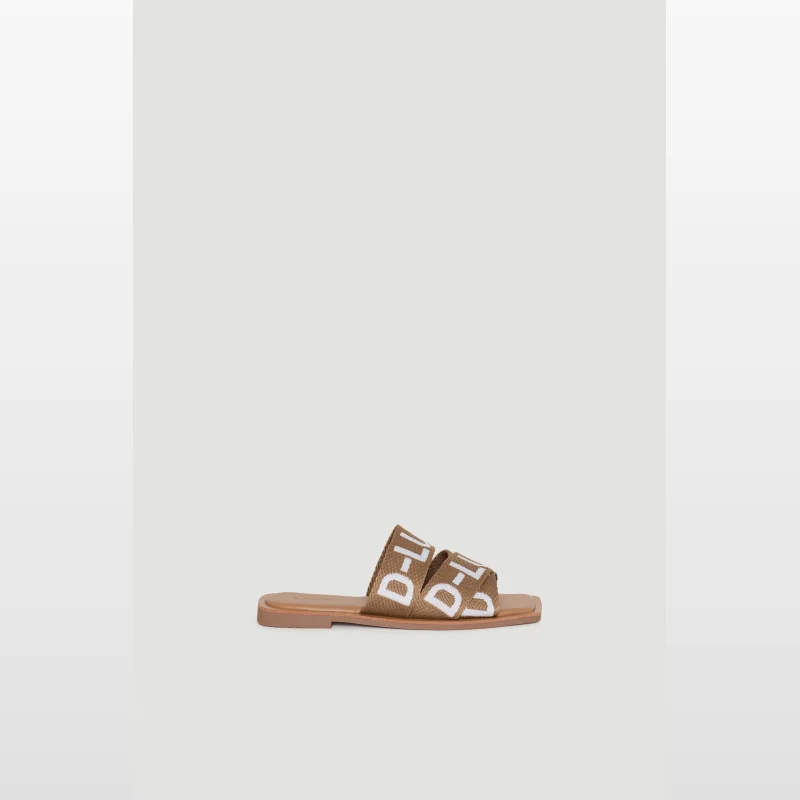 Decjuba D-Luxe Kia Tape Slide sandals in tan with white D-Luxe branding on the webbed upper and a squared open toe.